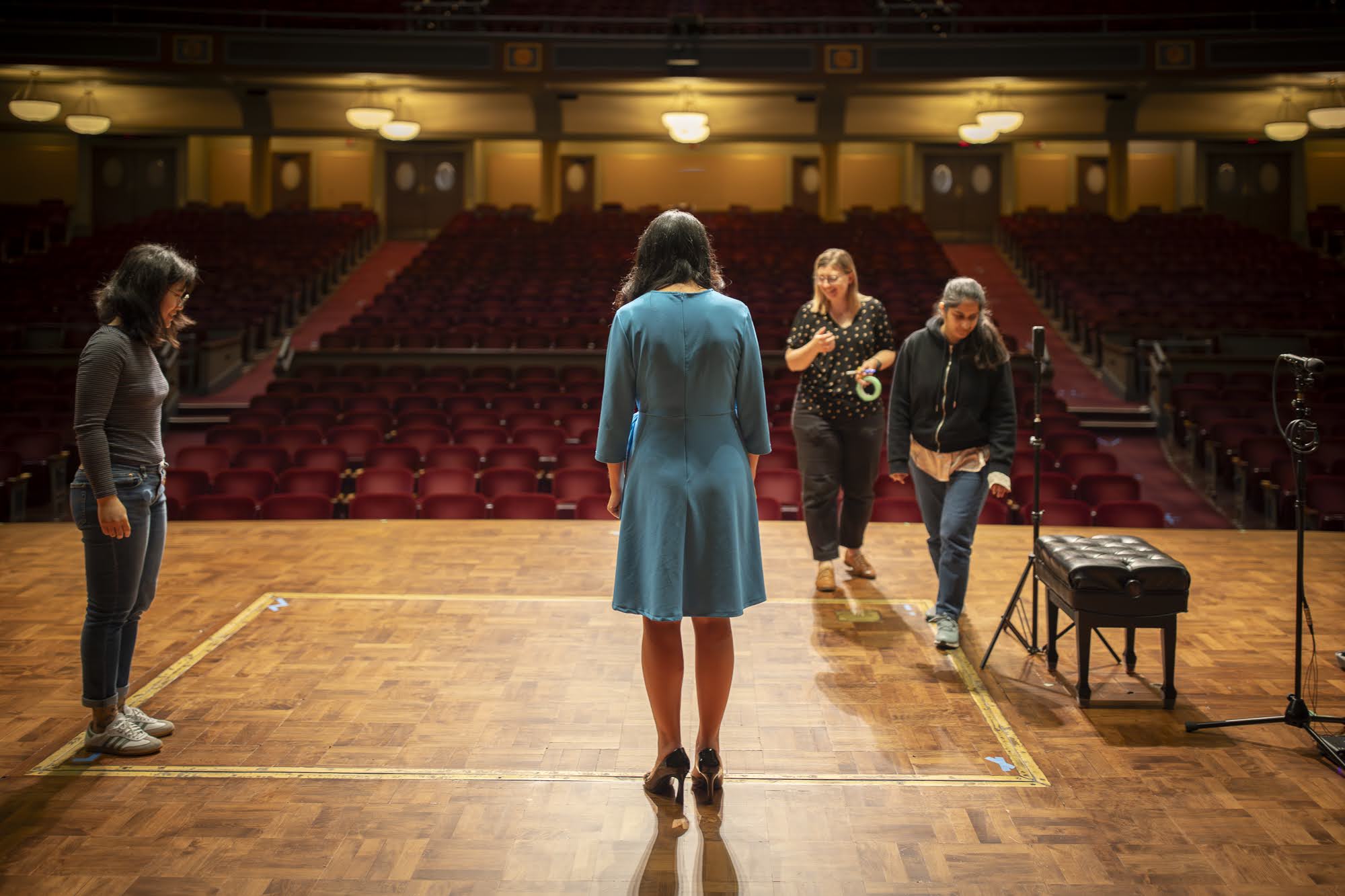 The team on the Hill Auditorium stage, facing the empty house