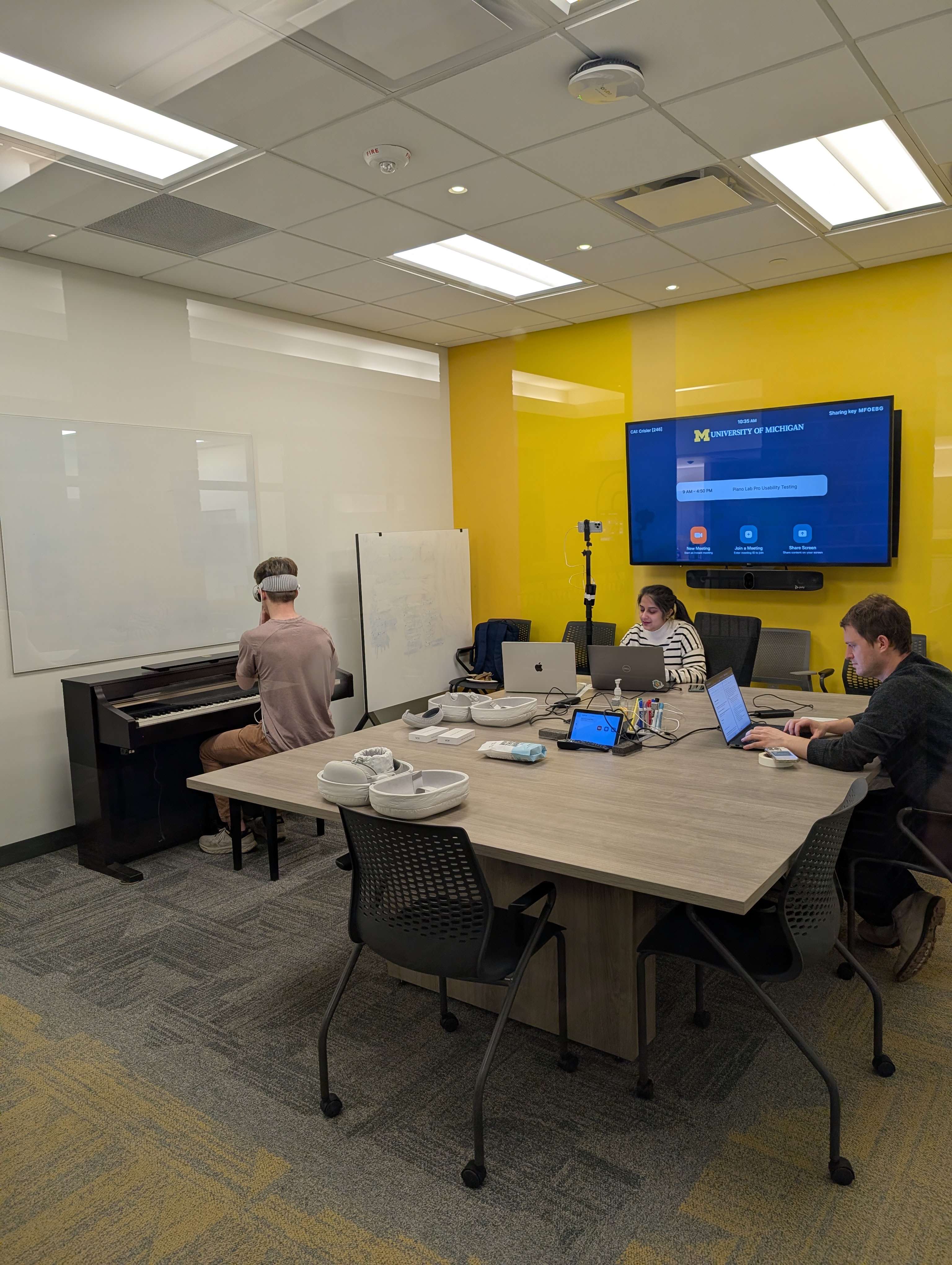 Student participant wearing Apple Vision Pro at the piano during a formal usability test session